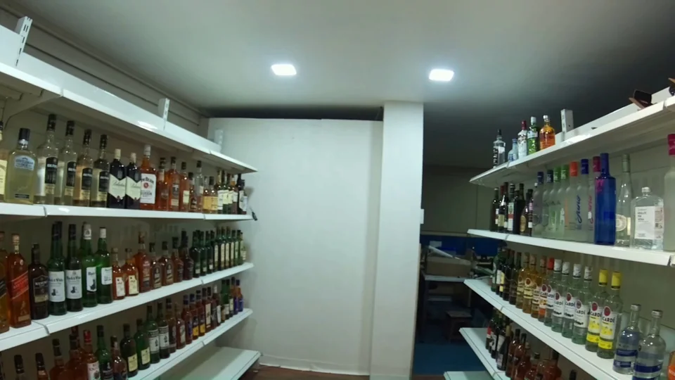 Later view along the bottle aisle with no person visible.